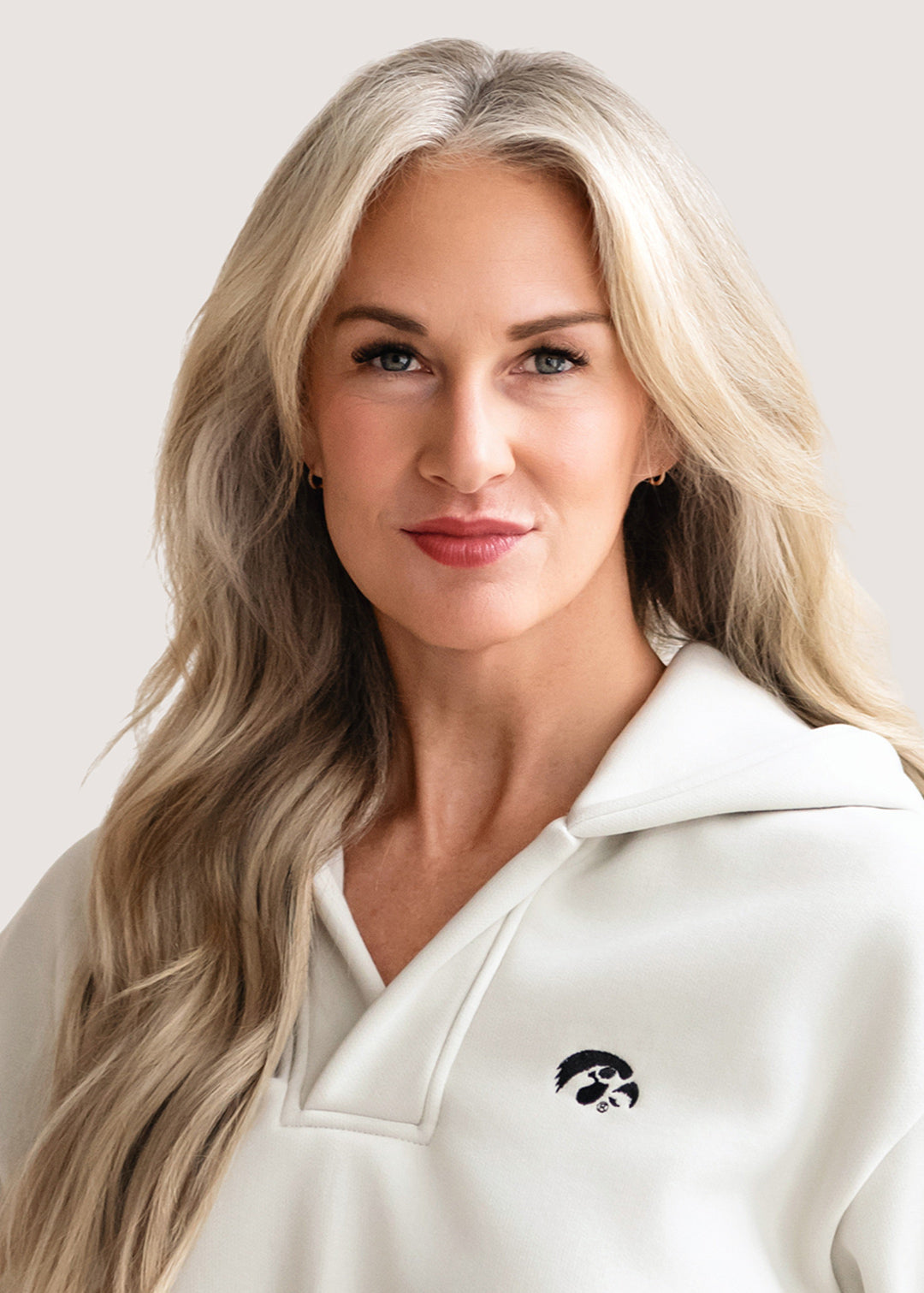 Woman wearing a white hoodie with a black Tigerhawk logo.