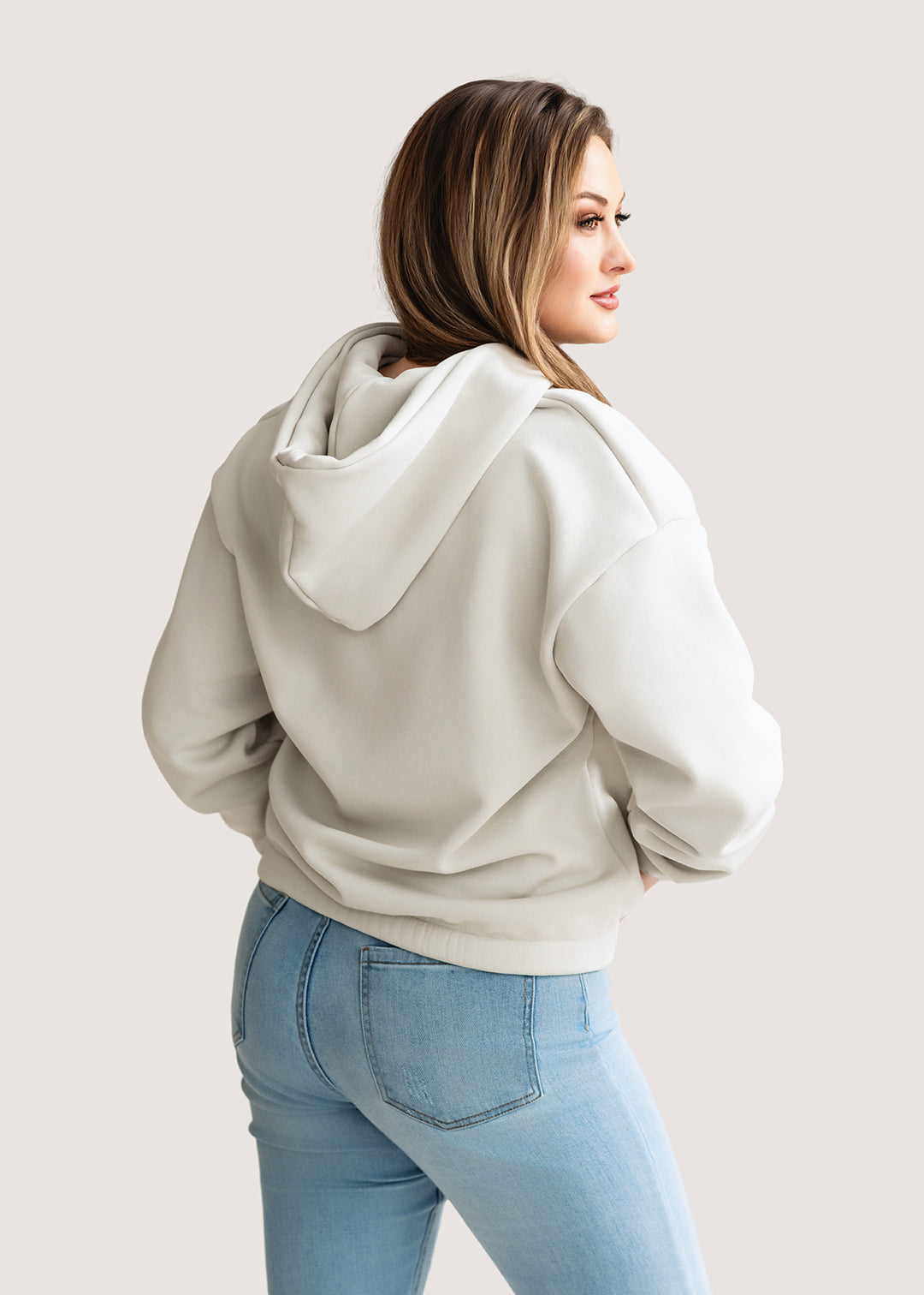 Woman wearing an ivory hoodie 