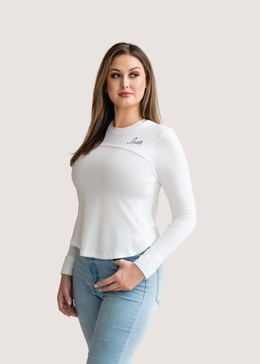 Woman wearing a long sleeve white shirt with a black Iowa script logo.